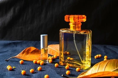 gold-perfume-bottle-and-orange-leaves-free-photo gold-perfume-bottle-and-orange-leaves-free-photo
